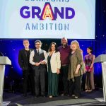 The Hodge Foundation Arts Award winners, Grand Ambition, on stage with Di Botcher