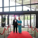 Two people standing on a red carpet